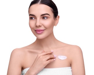 Photo of Beautiful woman with smear of body cream on her chest against white background