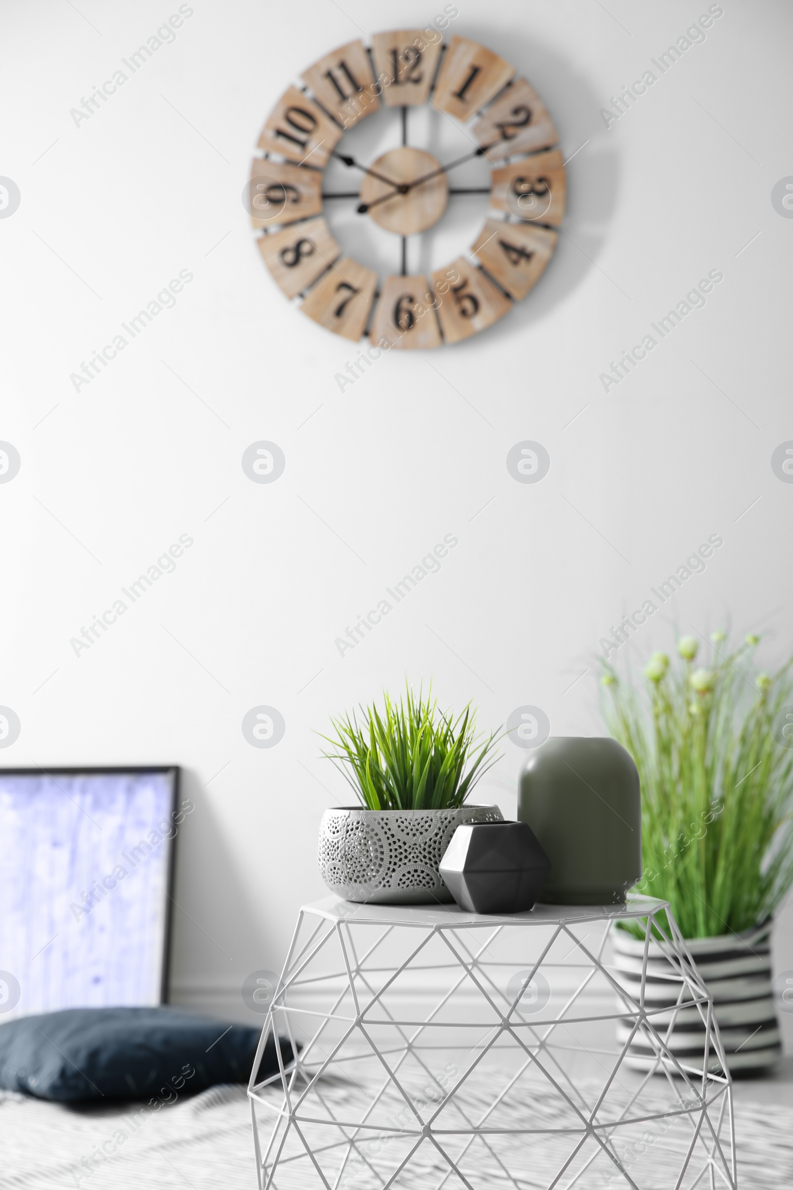 Photo of Beautiful vases and houseplant on table indoors. Idea for interior decor