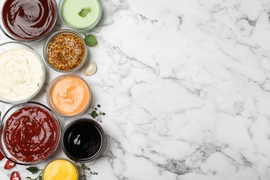 Photo of Many different sauces and herbs on white marble table, flat lay. Space for text