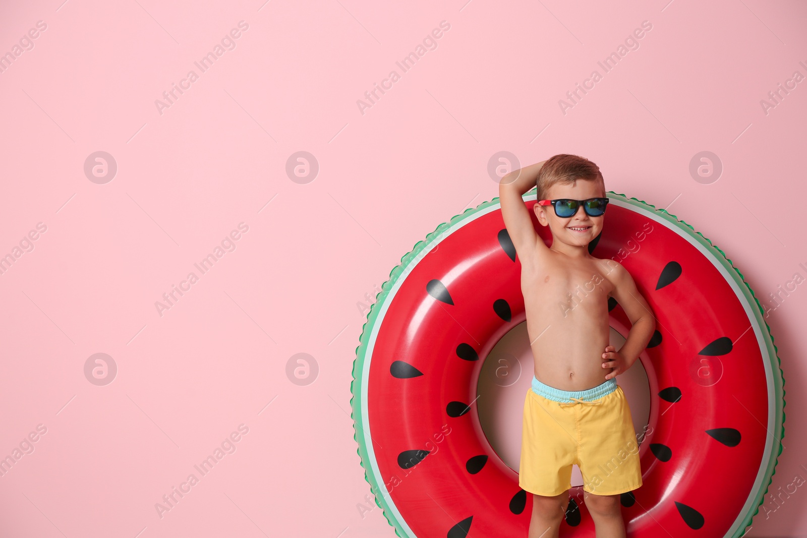 Photo of Cute little boy with inflatable ring on color background