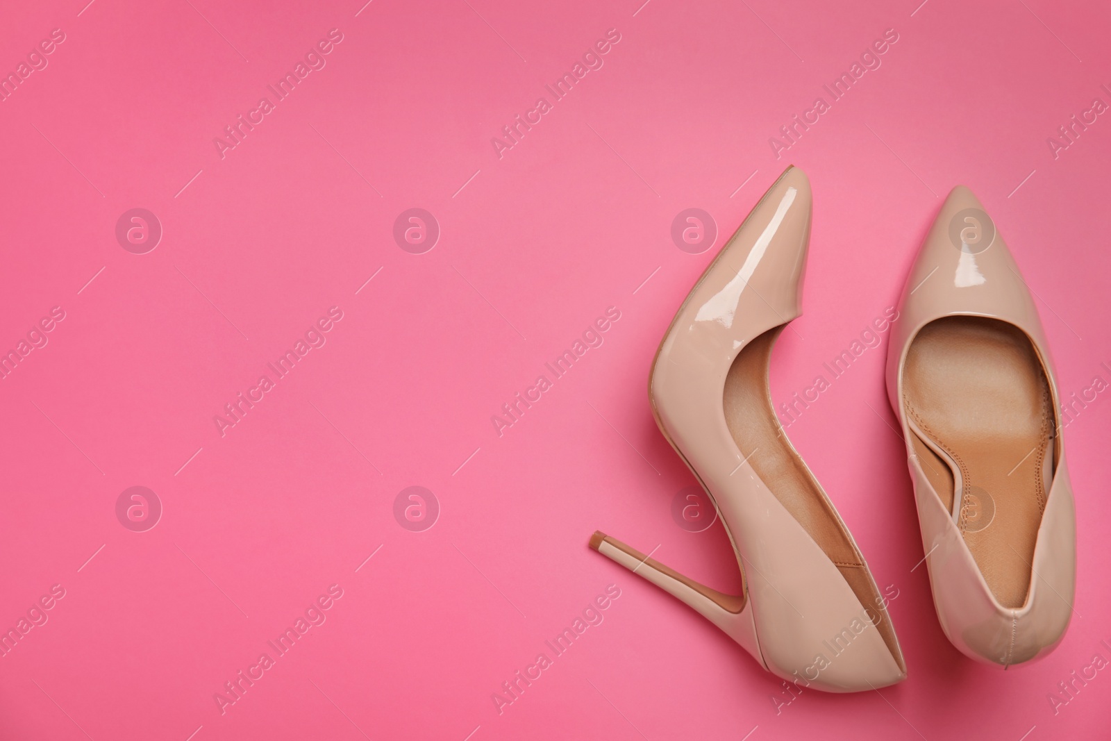 Photo of Pair of beautiful shoes and space for text on color background, top view