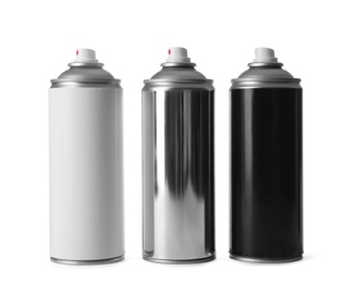 Photo of Cans of different spray paints on white background