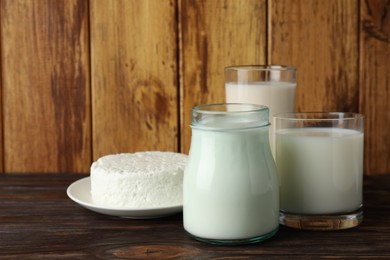 Fresh lactose free products on wooden table, space for text