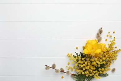 Photo of Beautiful floral composition with mimosa flowers on white wooden background, flat lay. Space for text