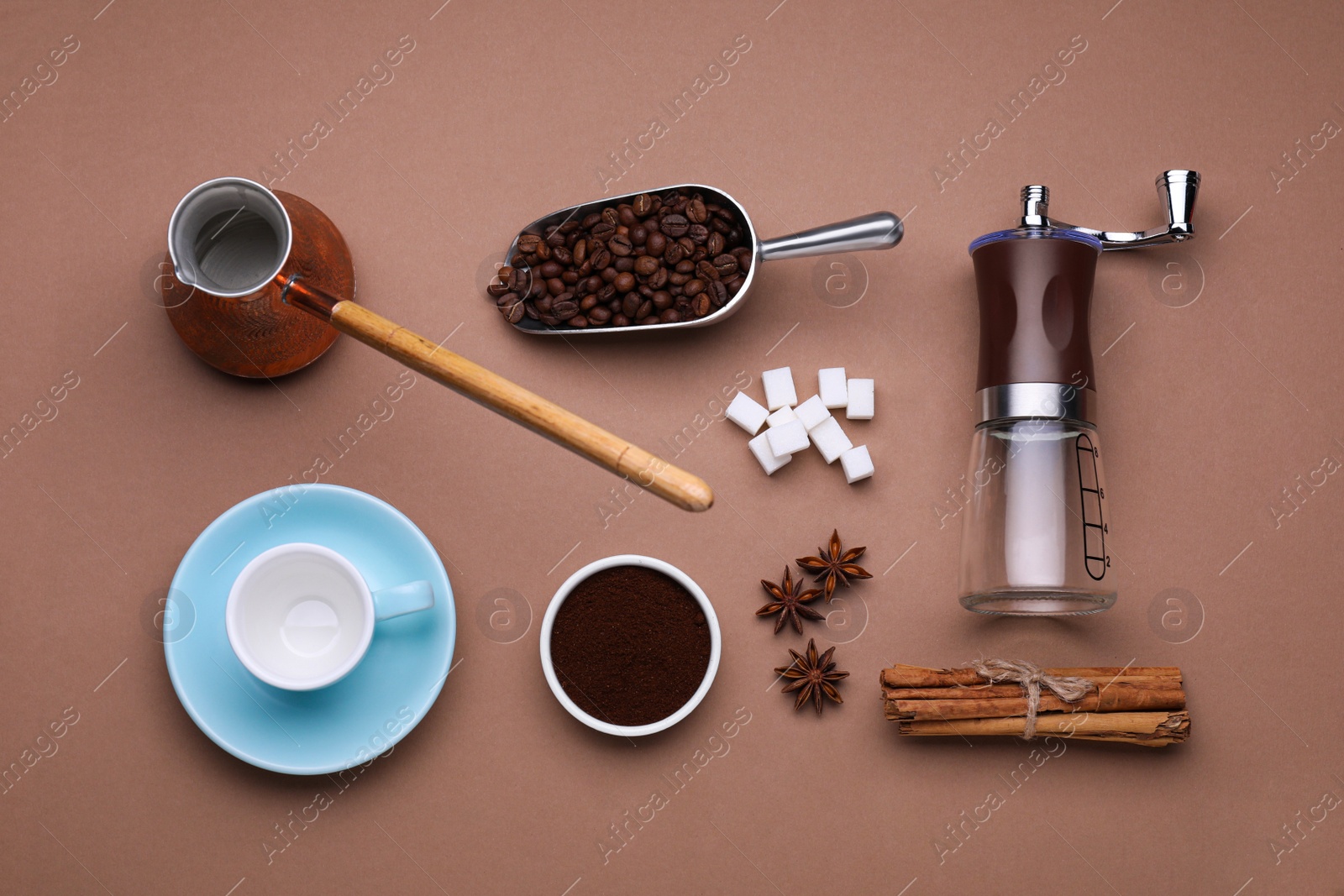 Photo of Flat lay composition with manual coffee grinder and spices on brown background