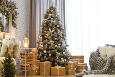 Photo of Room interior with decorated Christmas tree and gifts near window