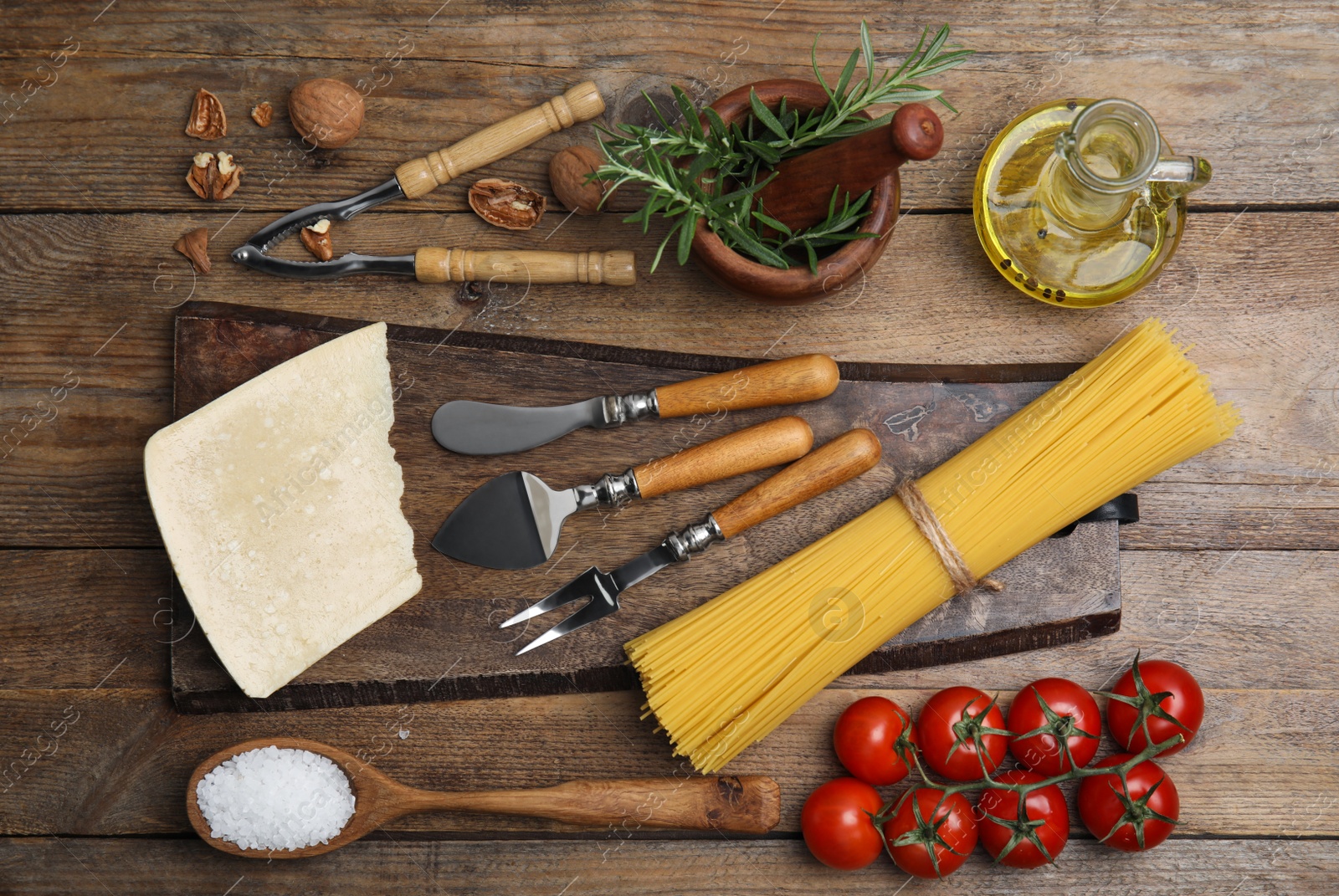 Photo of Flat lay composition with cooking utensils and fresh ingredients on wooden table