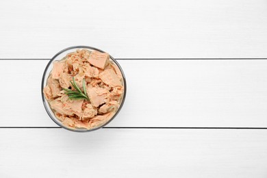 Photo of Bowl with canned tuna and rosemary on white wooden table, top view. Space for text