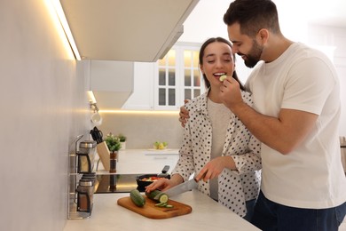 Photo of Happy lovely couple cooking together in kitchen