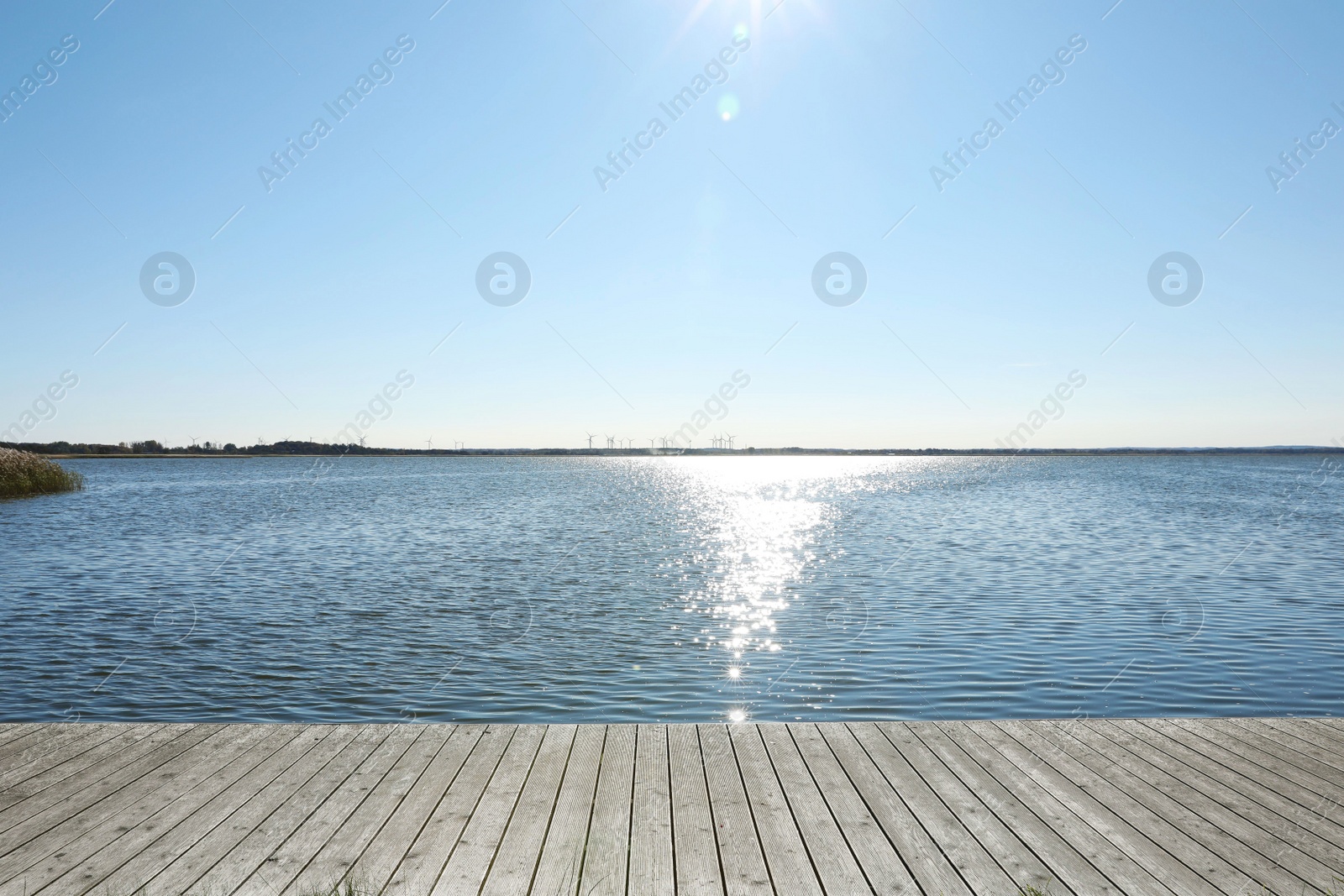 Photo of Beautiful view of wooden terrace near river on sunny day