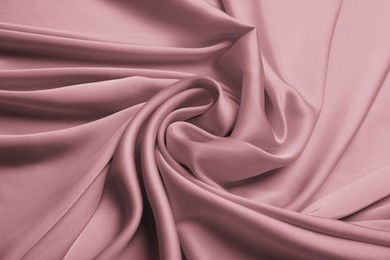 Delicate pink silk fabric as background, closeup view