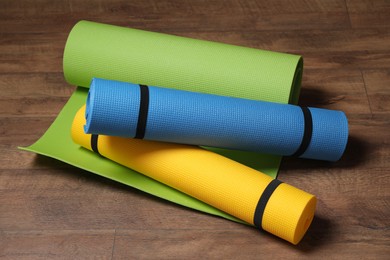 Photo of Bright camping or exercise mats on wooden background