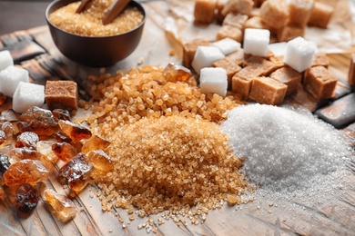 Different types of sugar on wooden table