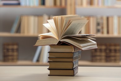 Photo of Stack of books on light table in library
