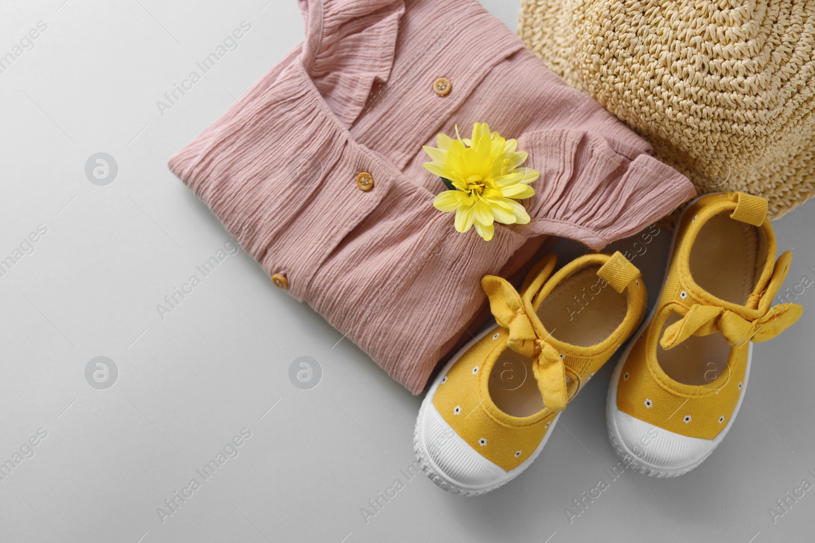 Photo of Stylish child clothes, shoes and hat on grey background, flat lay