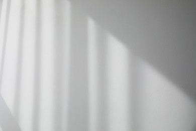 Photo of Shadow from window and curtains on white wall