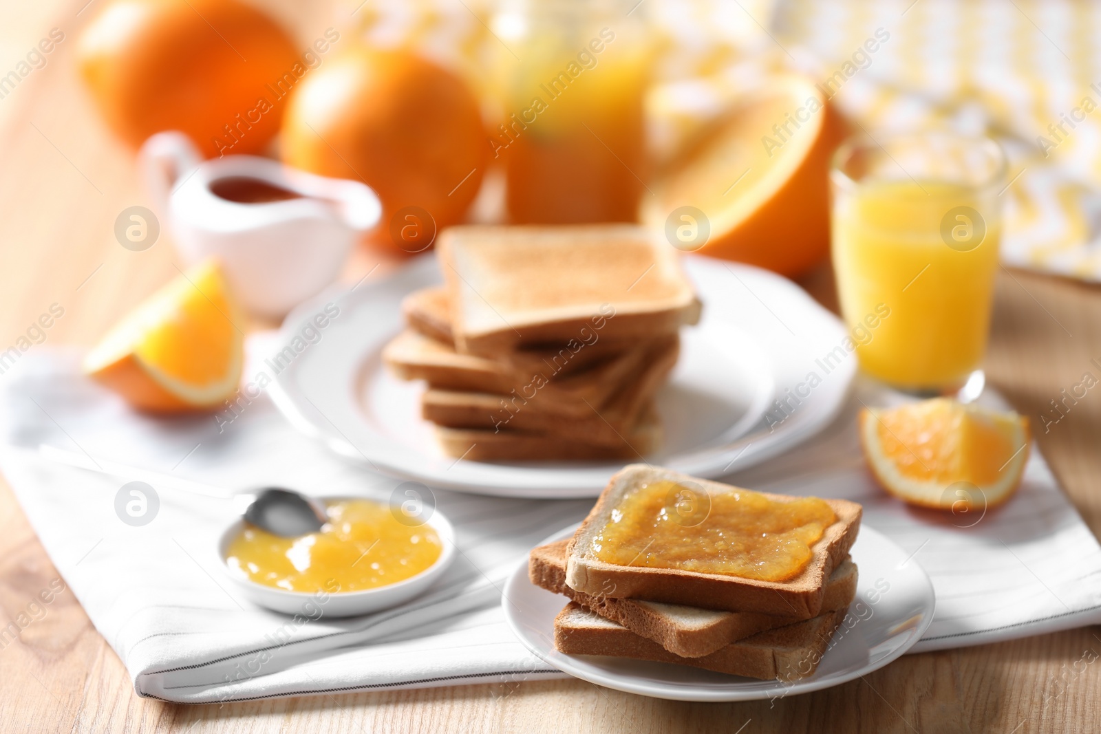 Photo of Delicious breakfast with toasts and jam on table