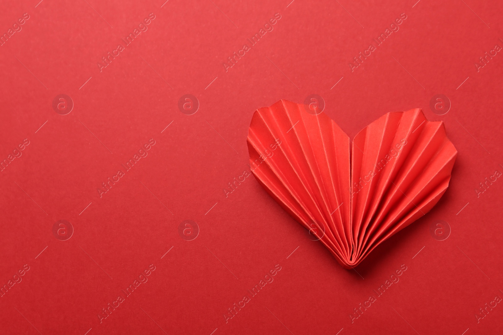 Photo of Decorative paper heart on red background, top view. Space for text