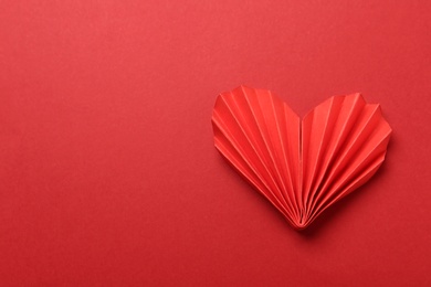 Photo of Decorative paper heart on red background, top view. Space for text