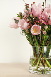 Beautiful bouquet with spring pink tulips on table