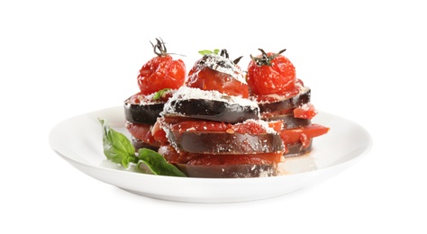 Baked eggplant with tomatoes, cheese and basil in plate isolated on white
