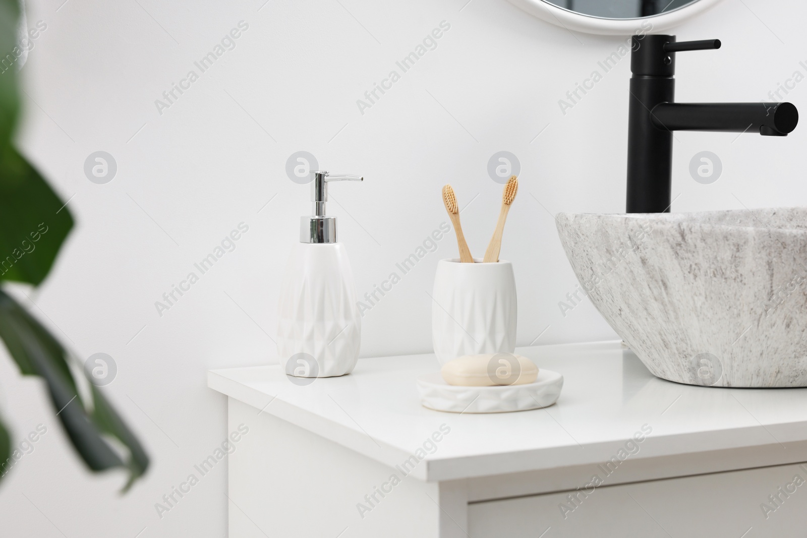 Photo of Different bath accessories and personal care products on bathroom vanity indoors