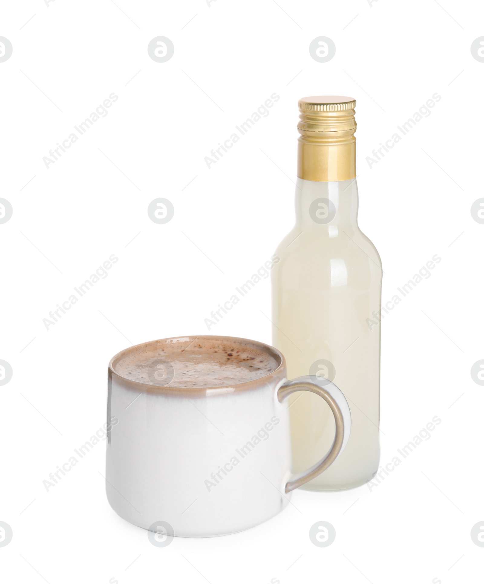 Photo of Bottle of delicious syrup and cup of coffee isolated on white