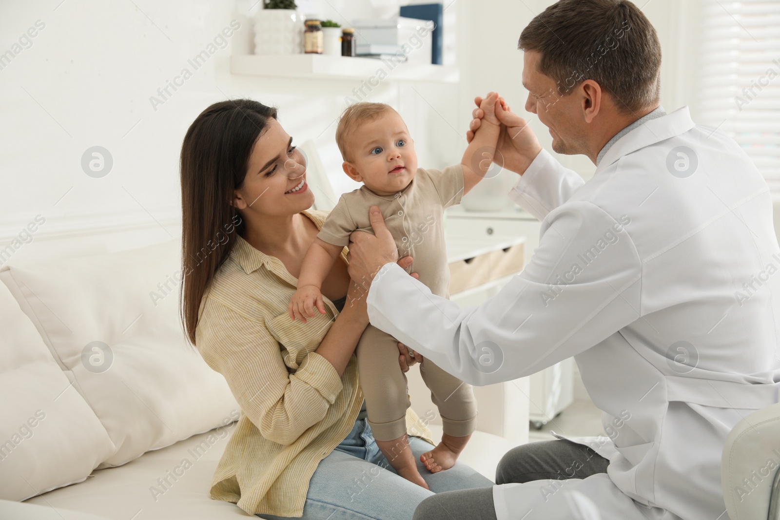 Photo of Mother with her cute baby visiting pediatrician in clinic