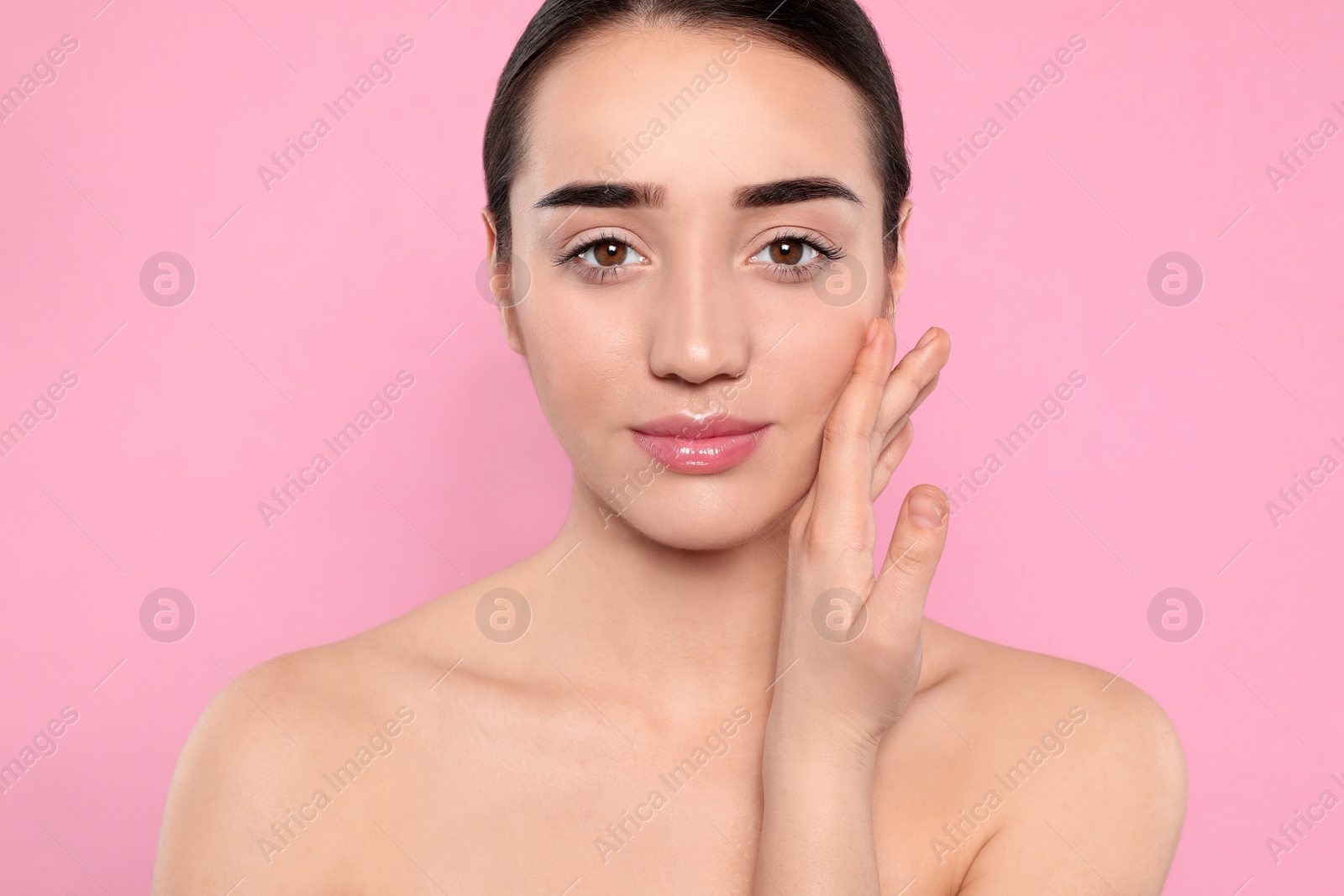 Photo of Portrait of young woman with beautiful face against color background