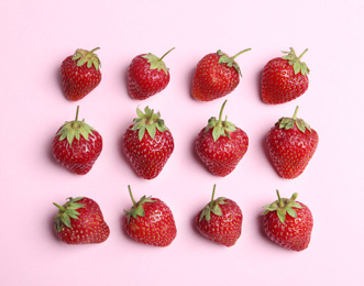 Photo of Tasty ripe strawberries on pink background, flat lay