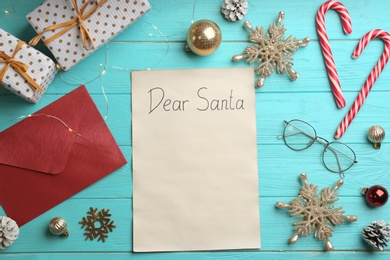 Flat lay composition with letter saying Dear Santa on turquoise wooden table, space for text