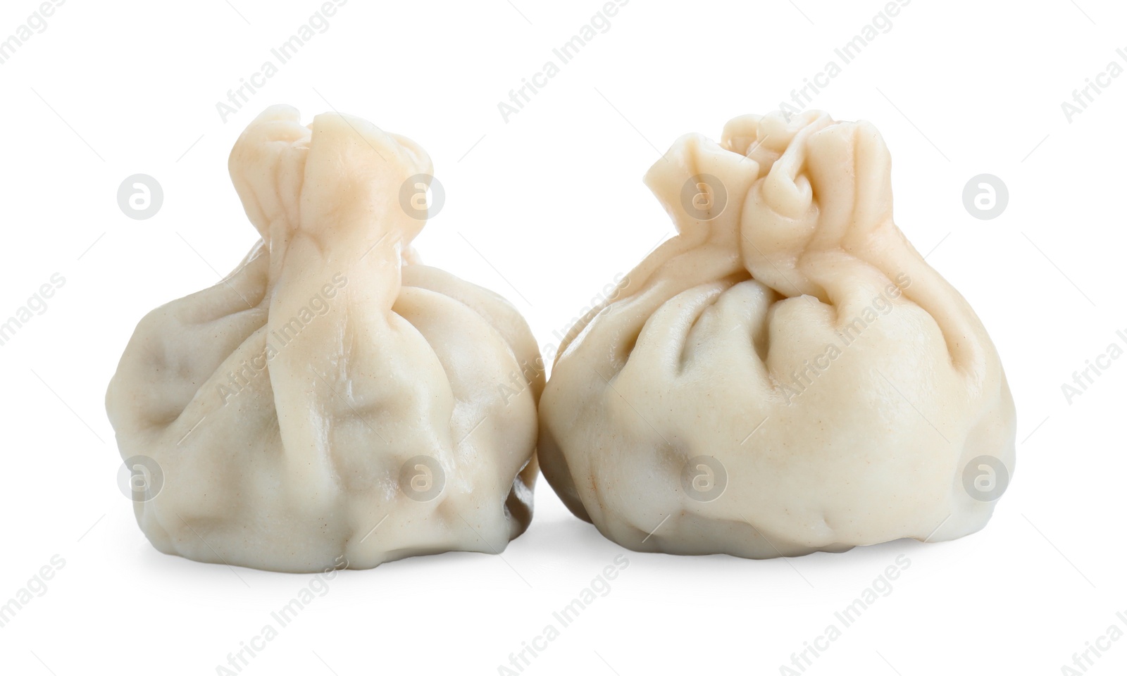 Photo of Two tasty khinkali (dumplings) isolated on white. Georgian cuisine