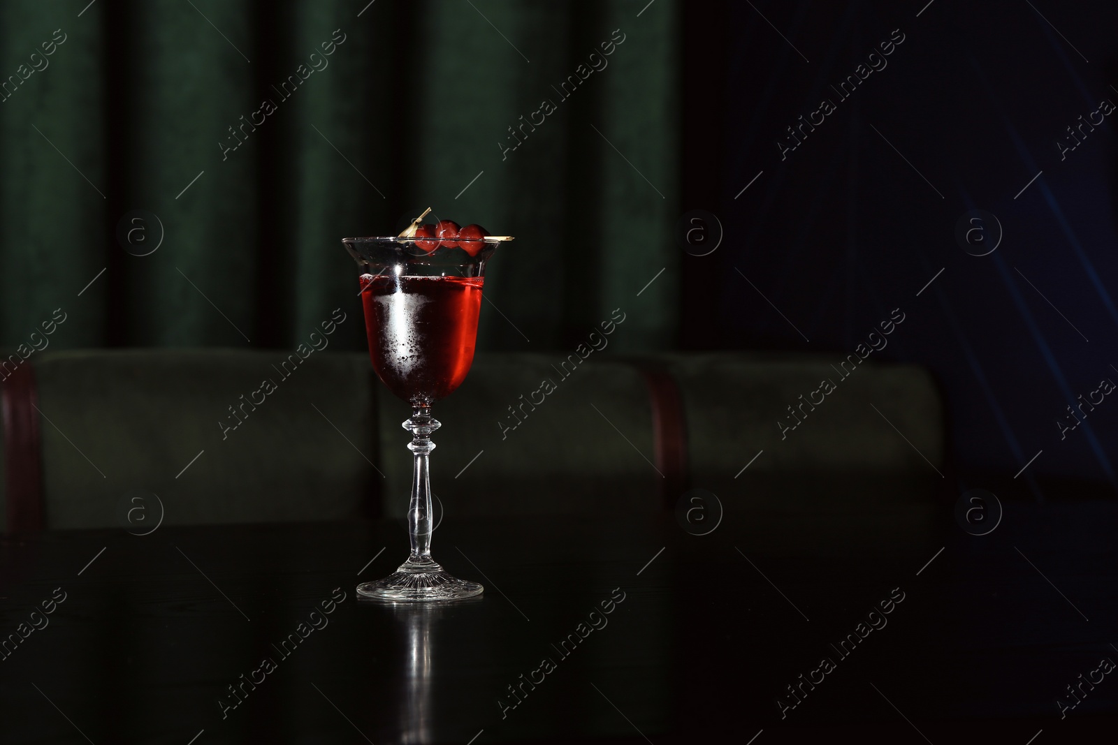 Photo of Fresh alcoholic Cherry blossom cocktail on bar counter. Space for text