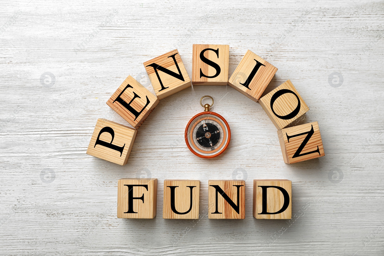 Photo of Flat lay composition with words PENSION FUND and compass on wooden background