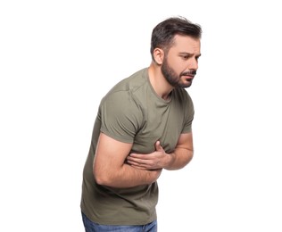 Photo of Unhappy man suffering from stomach pain on white background