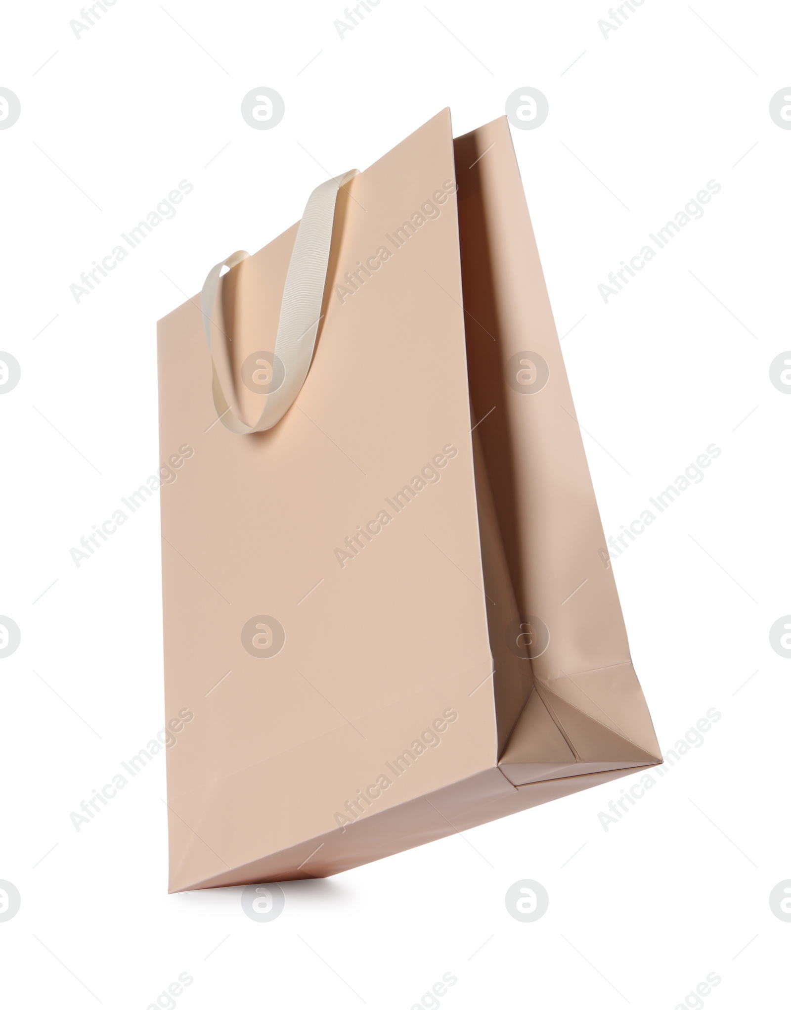 Photo of One beige shopping bag isolated on white