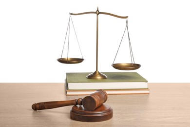 Photo of Law concept. Judge's mallet, scales of justice and books on wooden table against white background