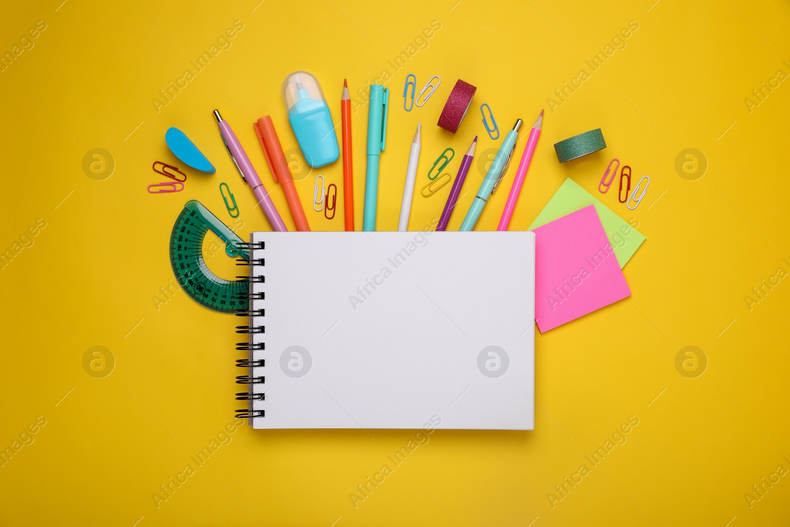 Photo of Flat lay composition with notebook and other school stationery on yellow background, space for text. Back to school