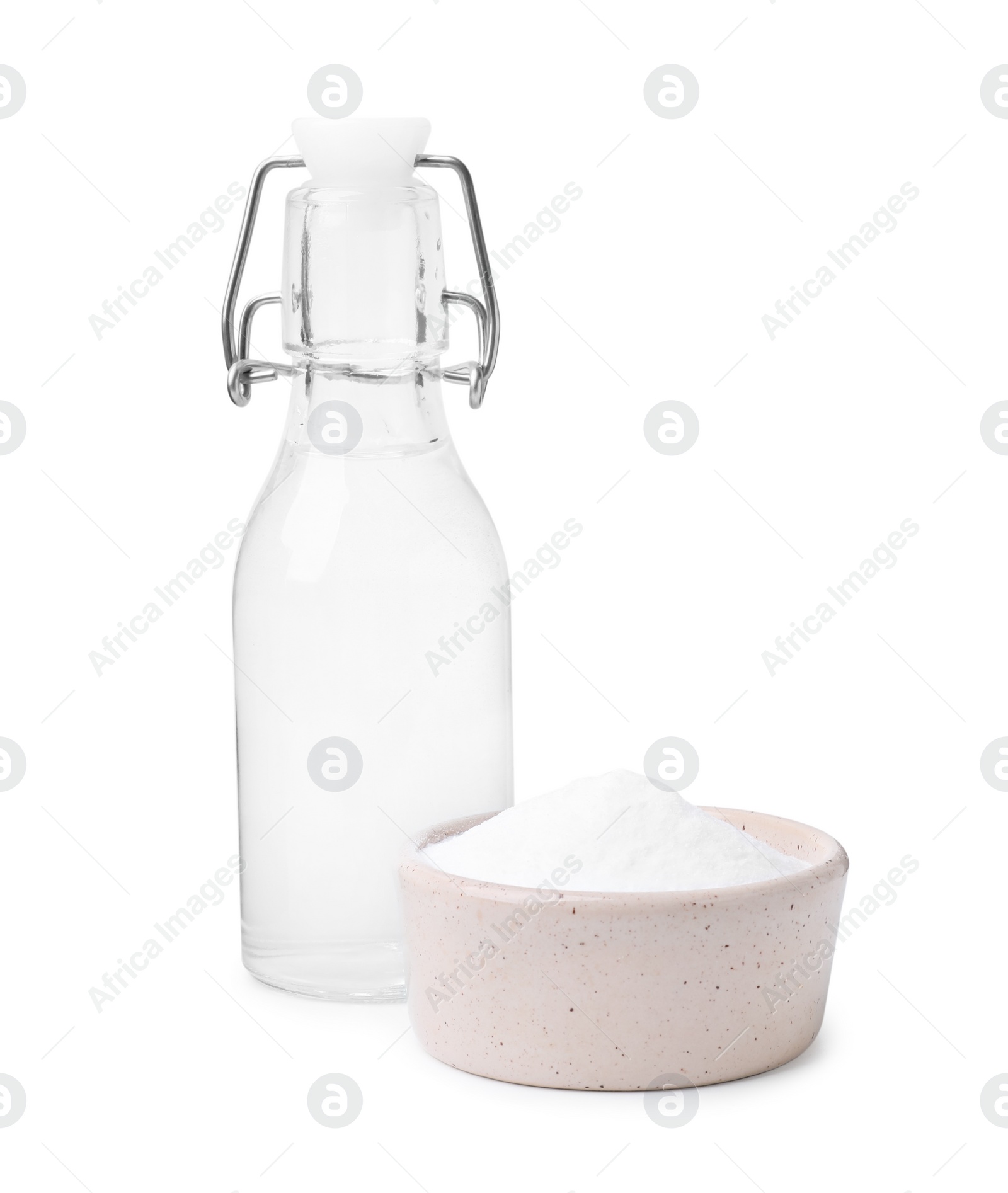 Photo of Vinegar in glass bottle and baking soda isolated on white