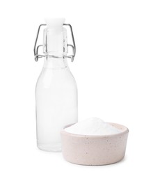 Photo of Vinegar in glass bottle and baking soda isolated on white