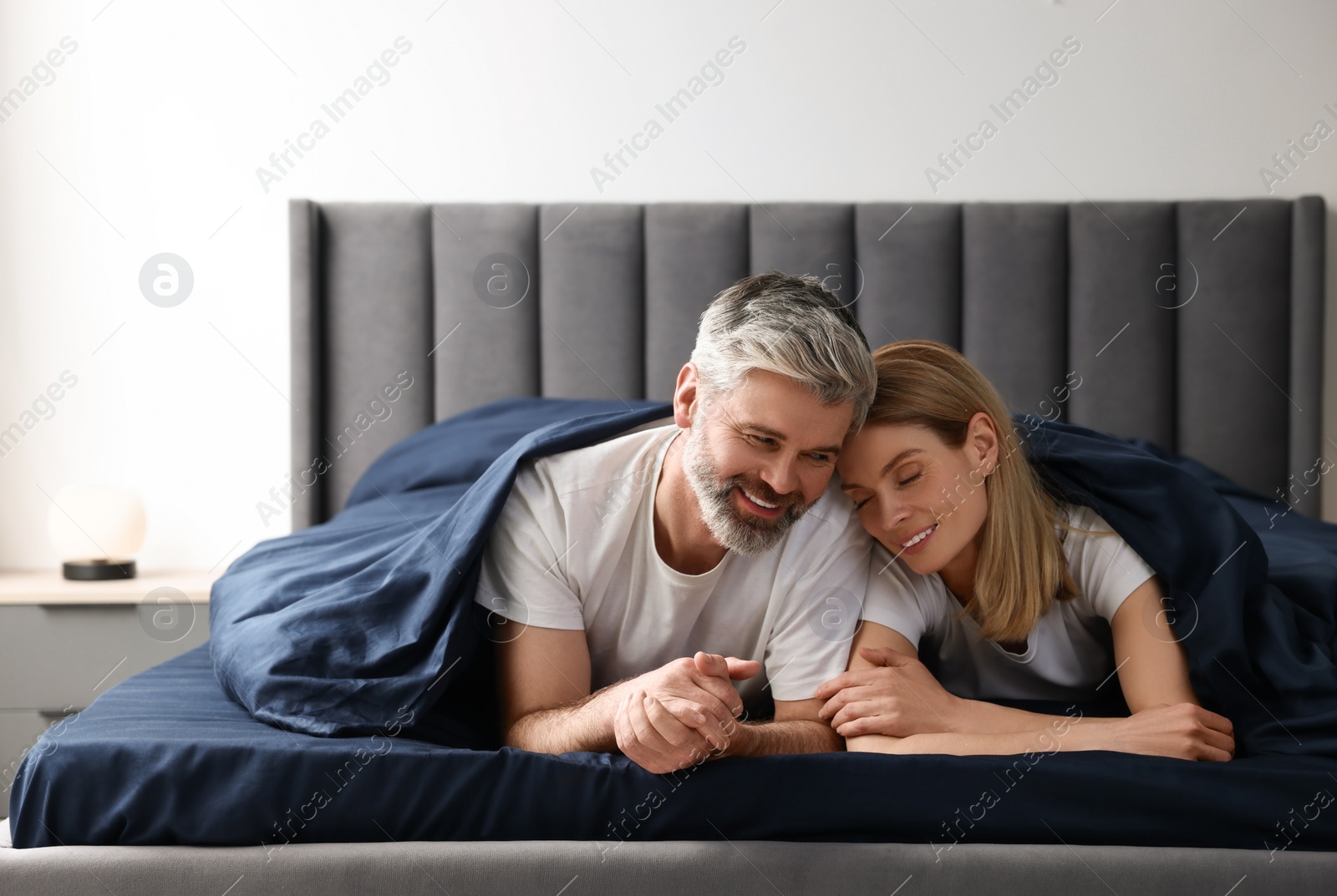 Photo of Lovely mature couple in bed at home