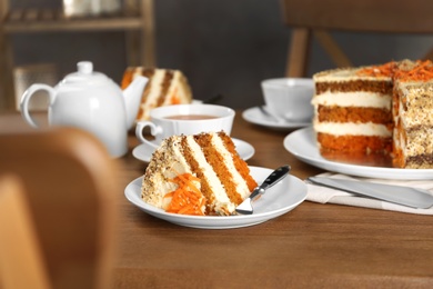 Photo of Tasty carrot cake served on wooden table