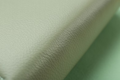 Photo of Beautiful green leather on table, closeup view