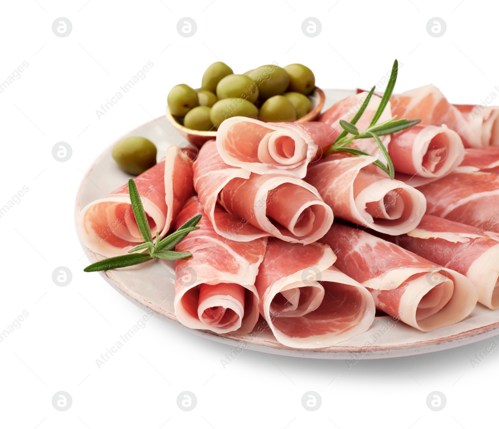 Photo of Plate with rolled slices of delicious jamon, olives and rosemary isolated on white