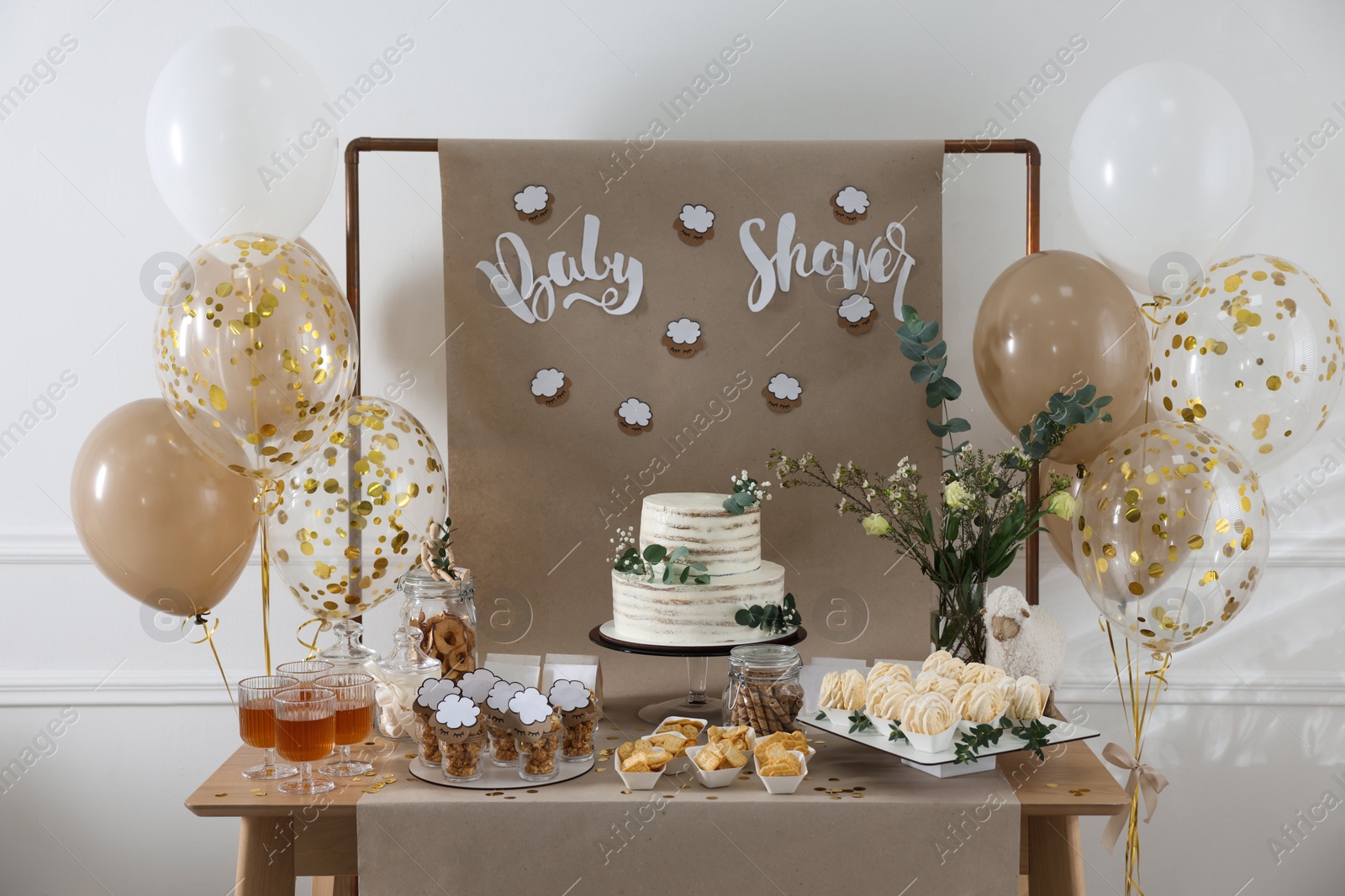 Photo of Beautiful cake and other treats on table in room. Baby shower party