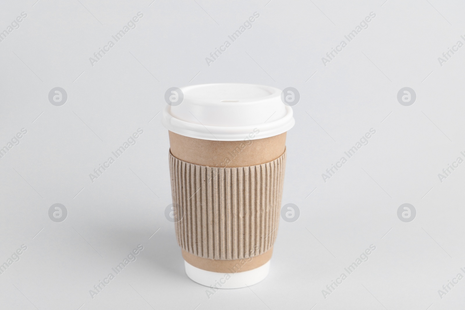 Photo of Paper cup with plastic lid on light background. Coffee to go