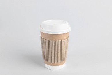 Photo of Paper cup with plastic lid on light background. Coffee to go