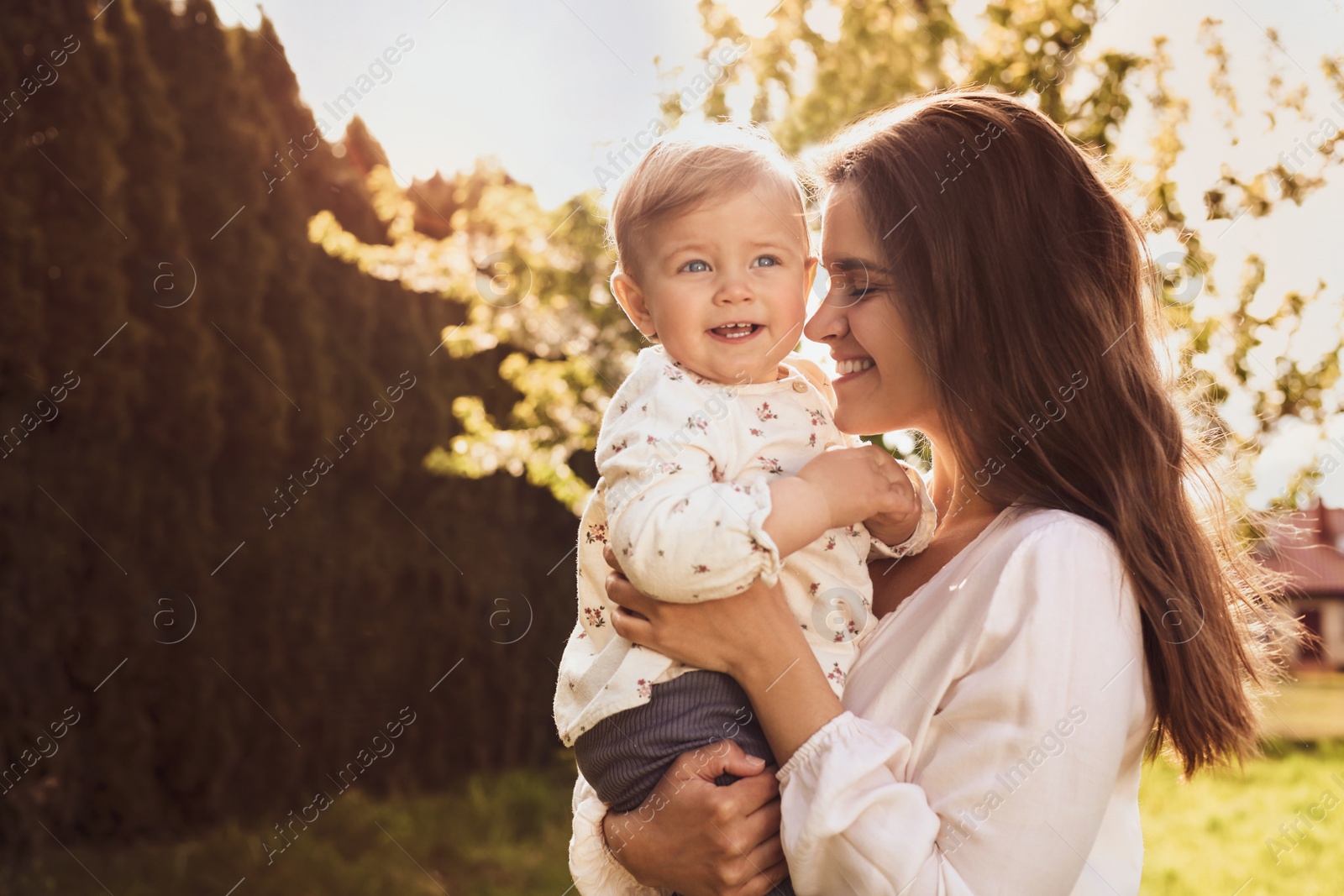 Image of Happy mother with her cute baby in park on sunny day