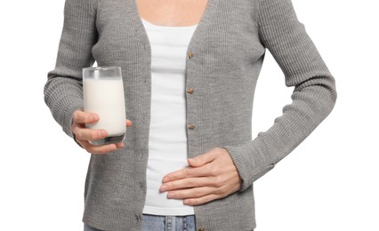 Photo of Woman with glass of milk suffering from lactose intolerance on white background, closeup