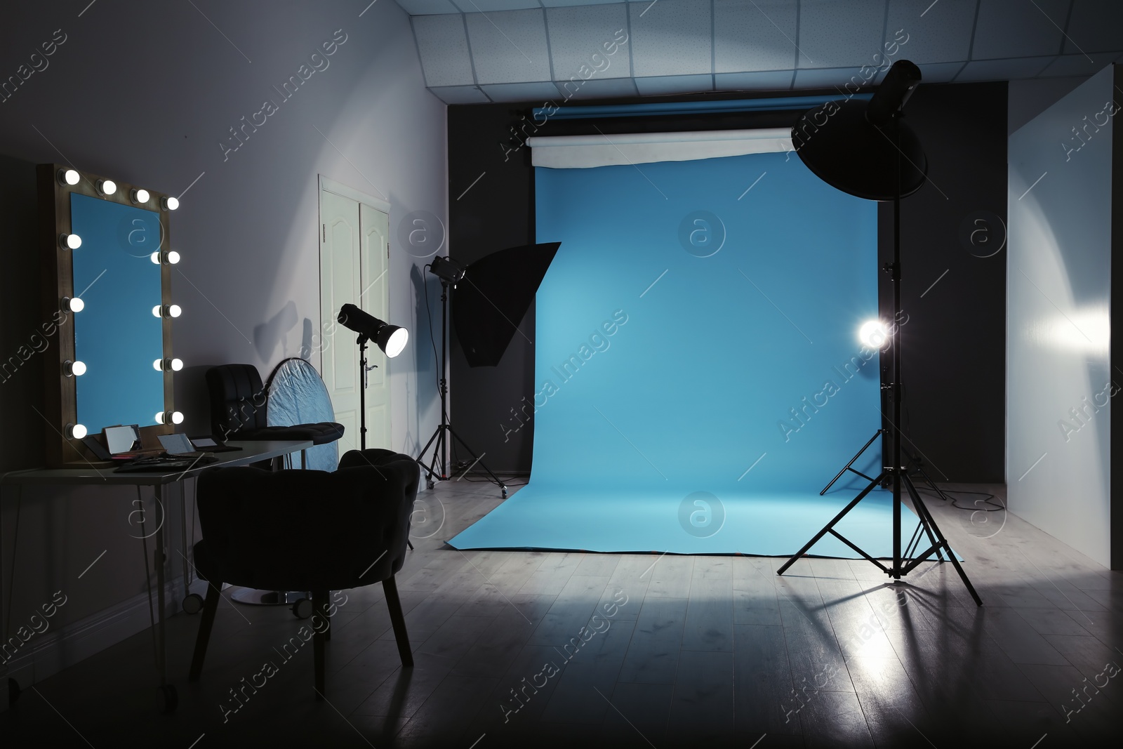 Photo of Modern photo studio interior with professional lighting equipment